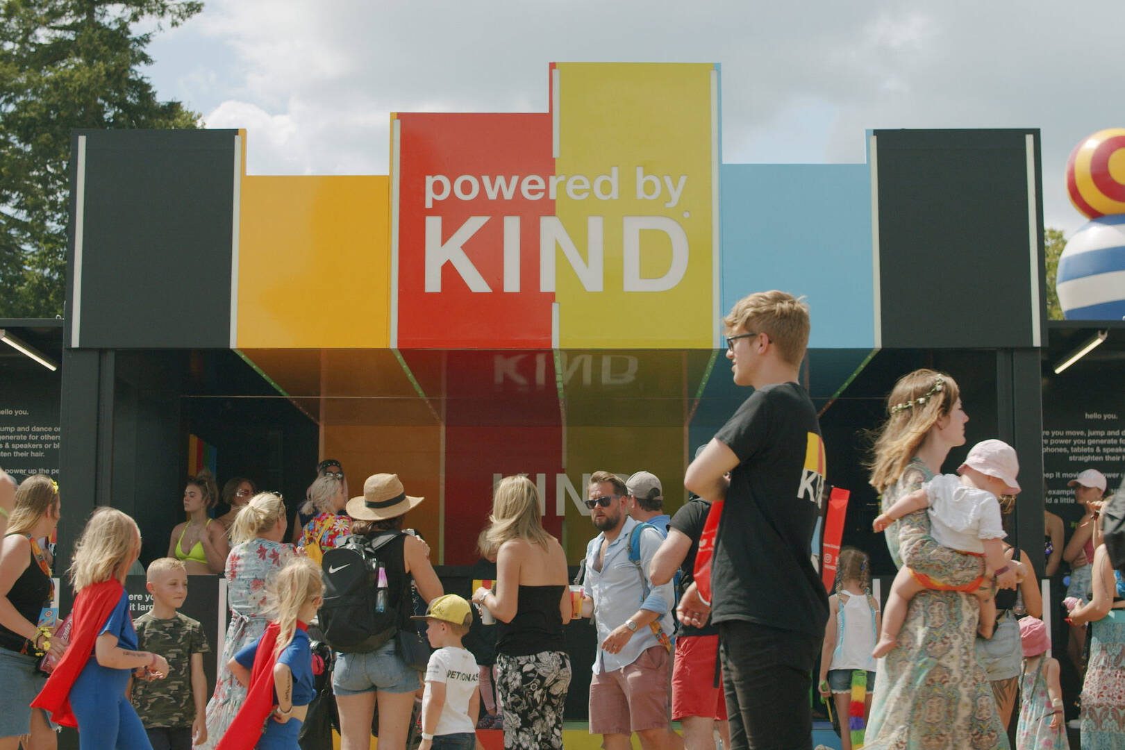 DJ booth and lively dance floor at Powered by Kind festival activation, filmed by our live action production team