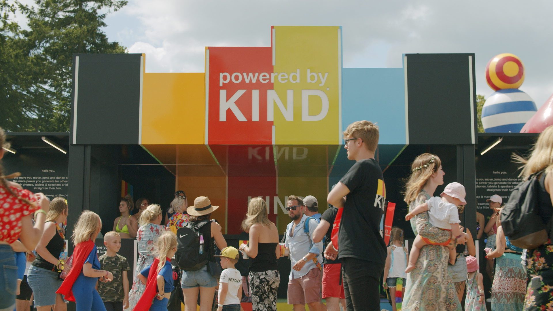 DJ booth and lively dance floor at Powered by Kind festival activation, filmed by our live action production team