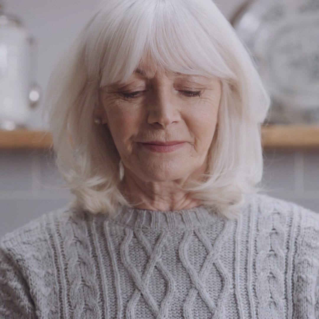 Close-up portrait of woman using Philips nebuliser respiratory device, captured in high-quality healthcare video production