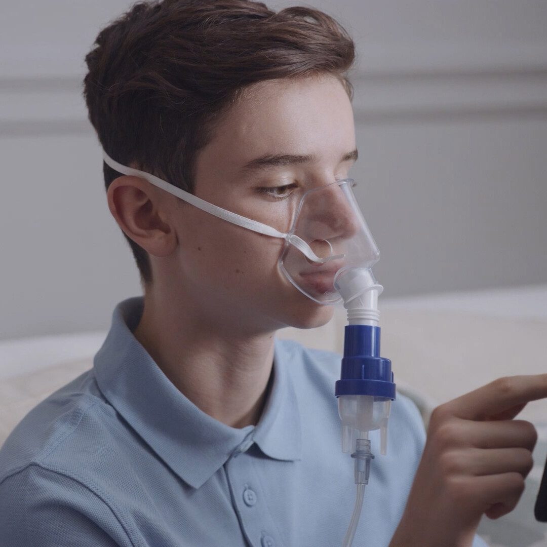 Live action shot of teenager using Philips respiratory nebuliser device during ‘How to’ video tutorial filmed by our studio