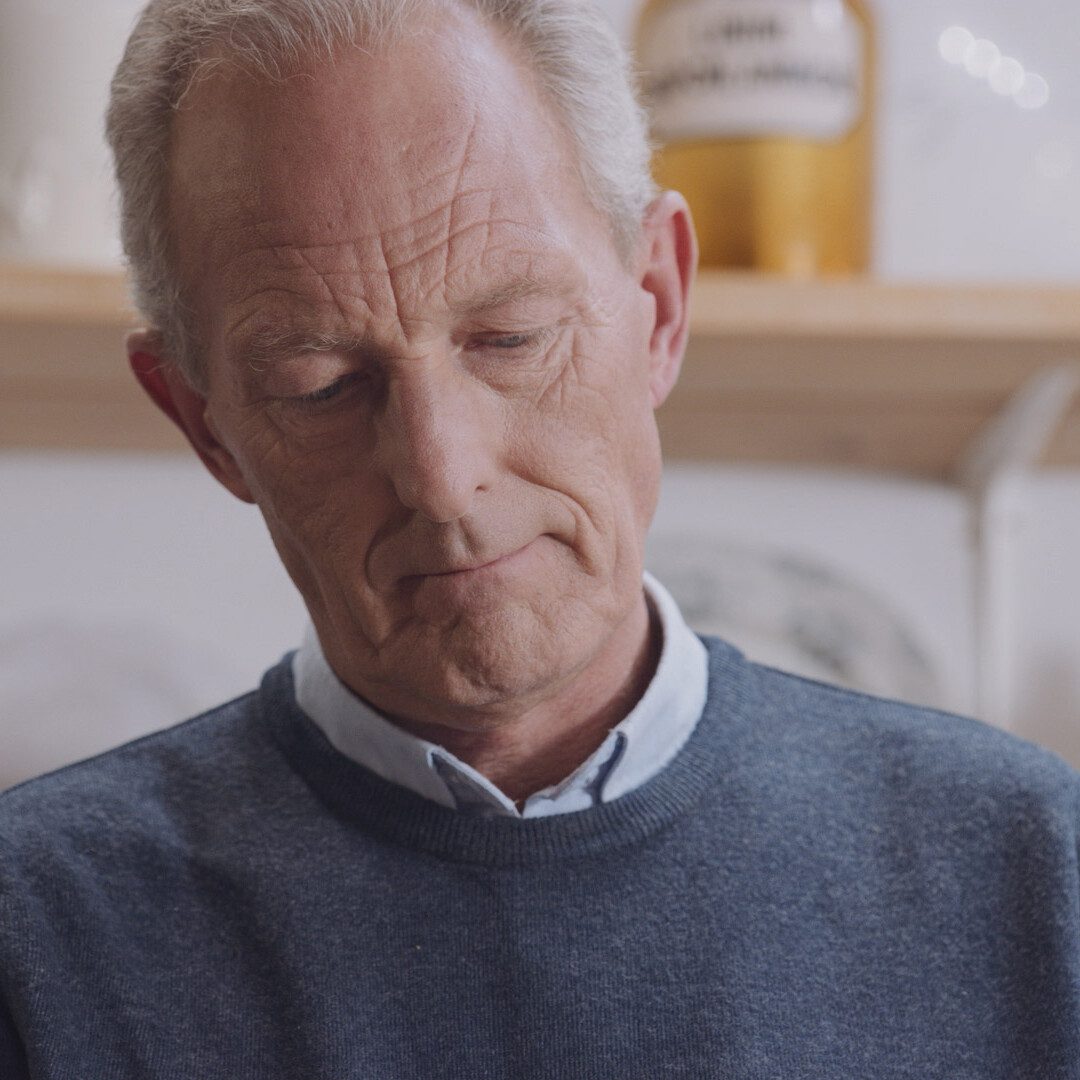 Close-up portrait of man using Philips nebuliser respiratory device, showcasing focused expression in high-quality healthcare video